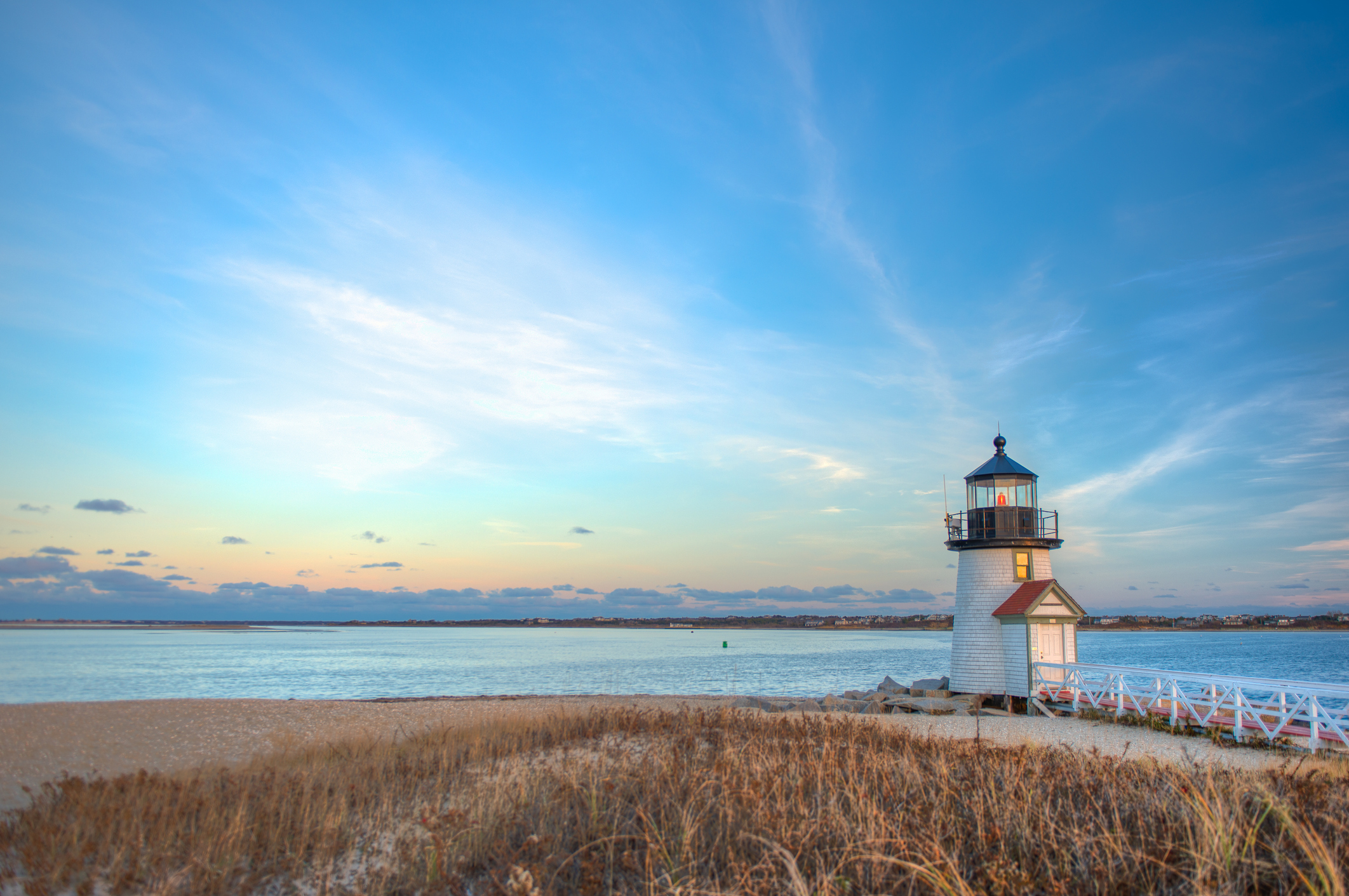 lighthouse overlooking coast and sunset on nantucket island