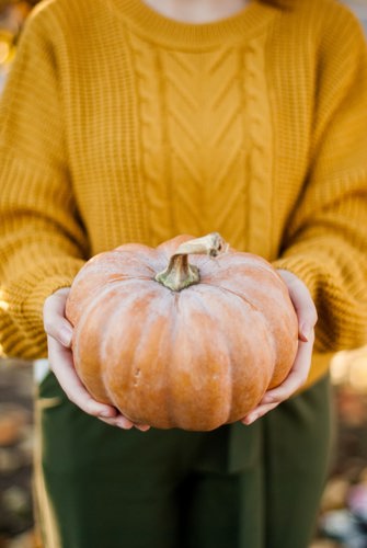 girl holding pumpkin