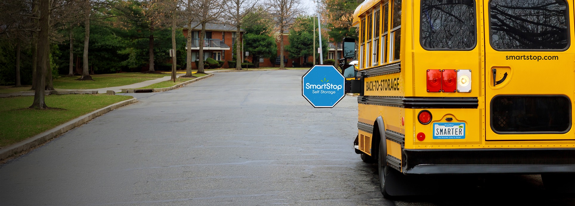 Image of SmartStop Branded School bus stopped in a neighborhood | SmartStop