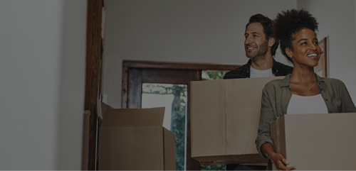 Image of couple carrying boxes for storage
