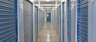 hallway inside storage facility with blue metal doors