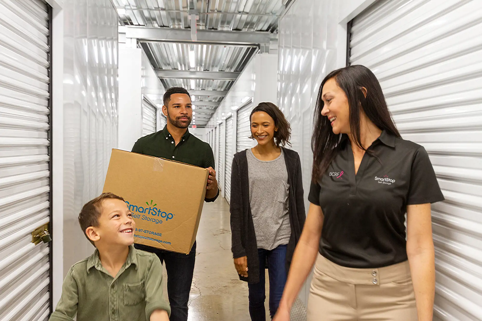 SmartStop employee showing a family to their storage unit.