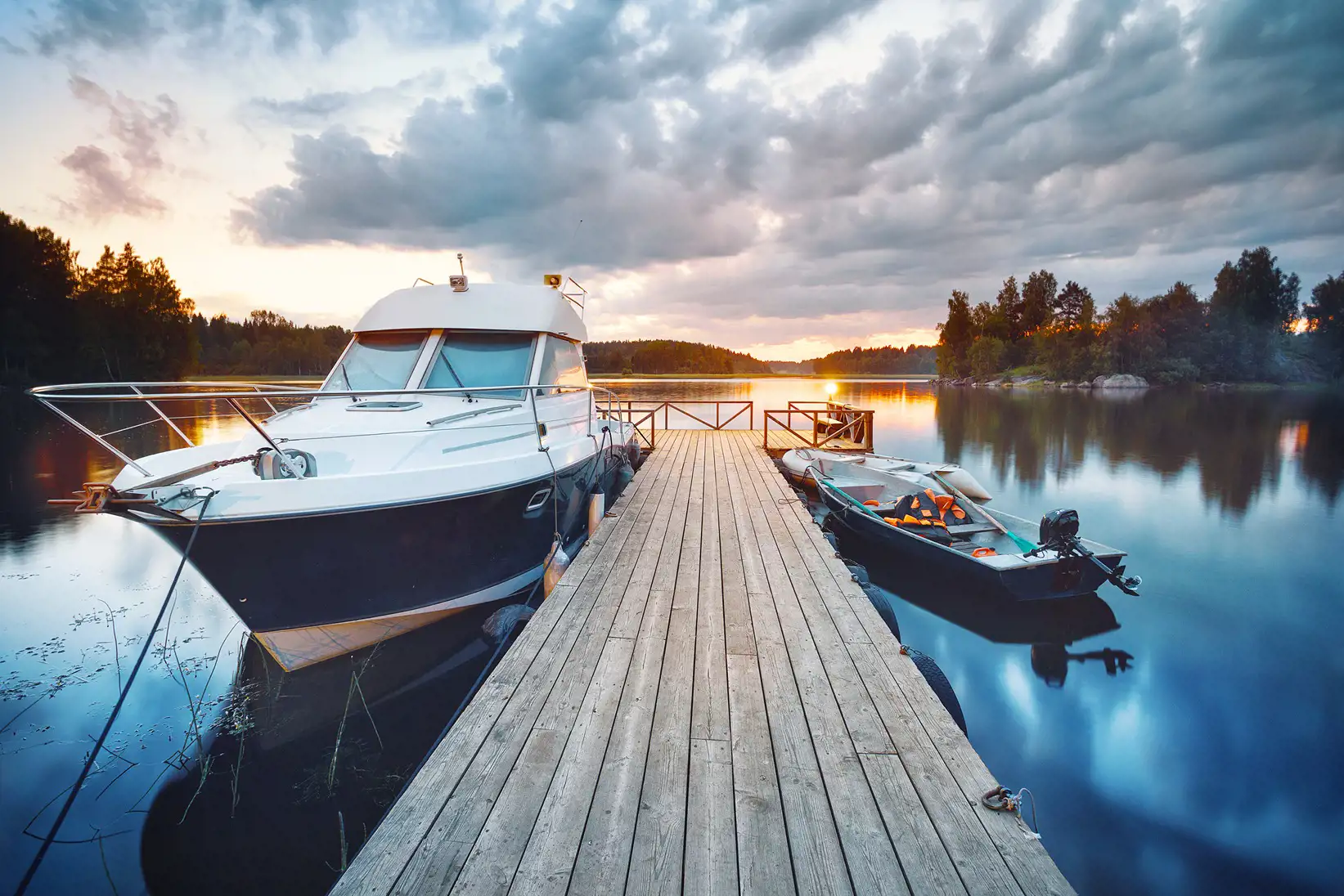 Image of boats parked at the dock waiting to be loaded on their trailers for storage.