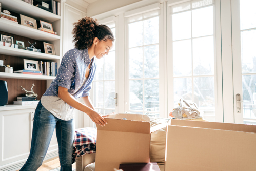 Woman unpacking boxes in new home
