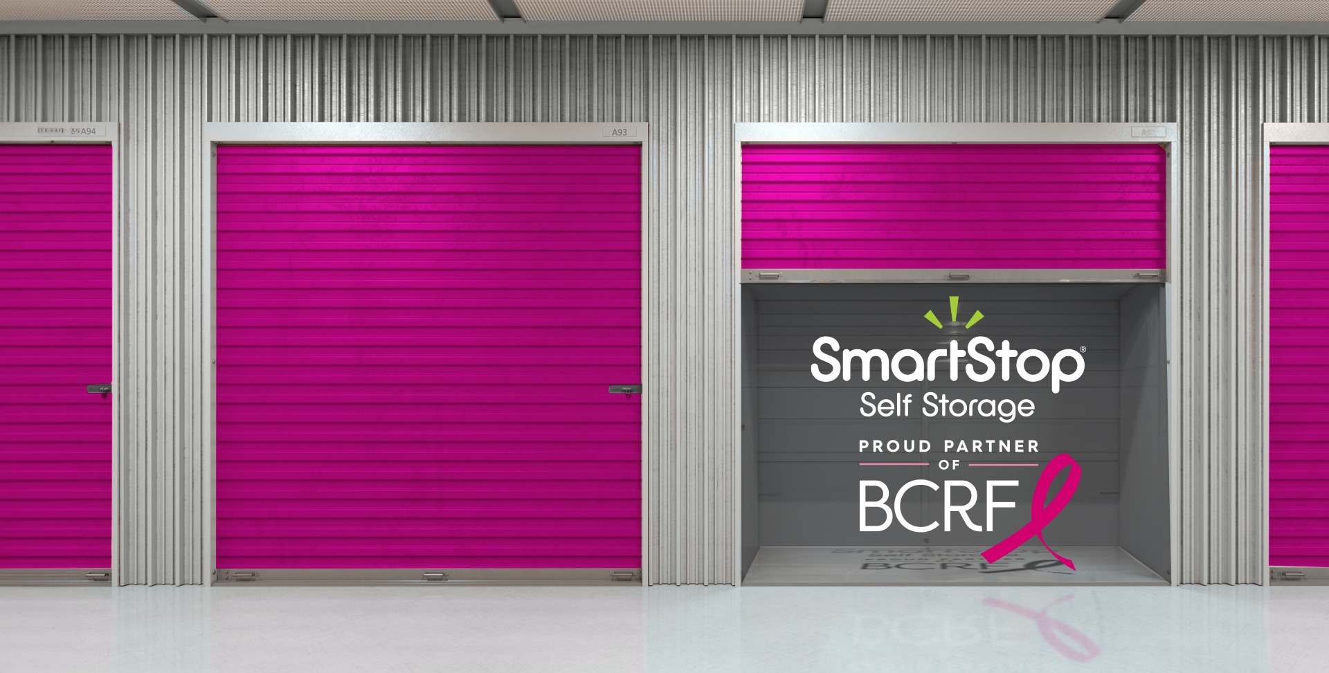 Row of Storage units with Pink doors, SmartStop logo and BCRF logo in honor of fund raising efforts for BCRF savings on storage | SmartStop Self Storage 