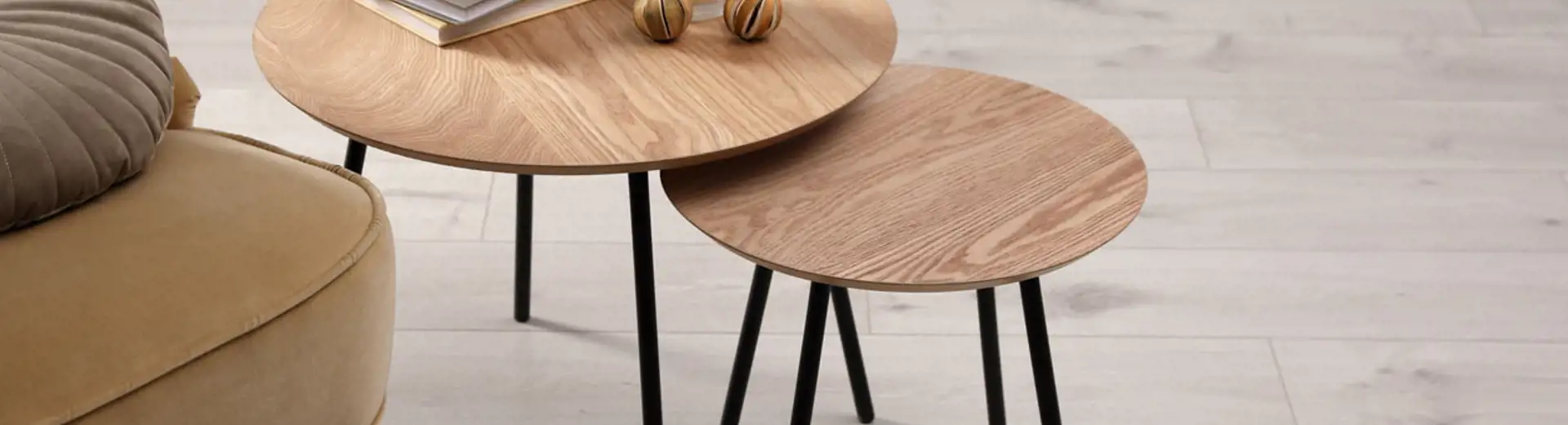 two nesting tables beside an armchair