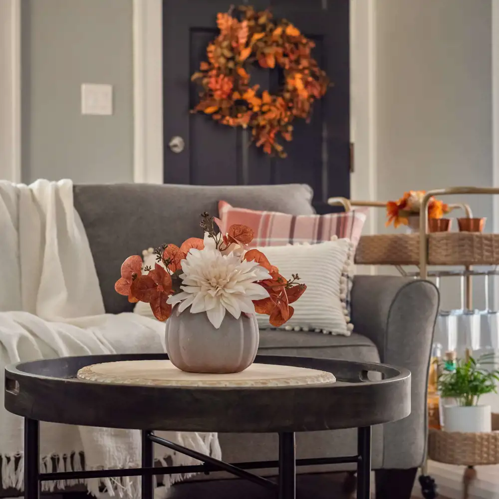 cozy fall living room with throw blanket patterned pillow wreath on door